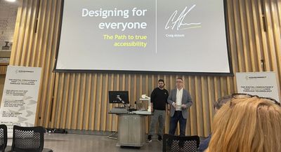 Craig and a co-presenter open their Tech Next session beneath a title slide reading "Designing for everyone: the path to true accessibility", flanked by sponsor banners.