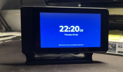 The same Raspberry Pi kiosk running the bundled demo: a full-screen clock showing 22:20 on Thursday 23 July, with a footnote saying to edit demo/public/index.html to build your own kiosk screen.