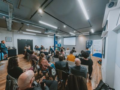 A room full of people at A11y North. Craig is about to start his talk on accessibility and AI.