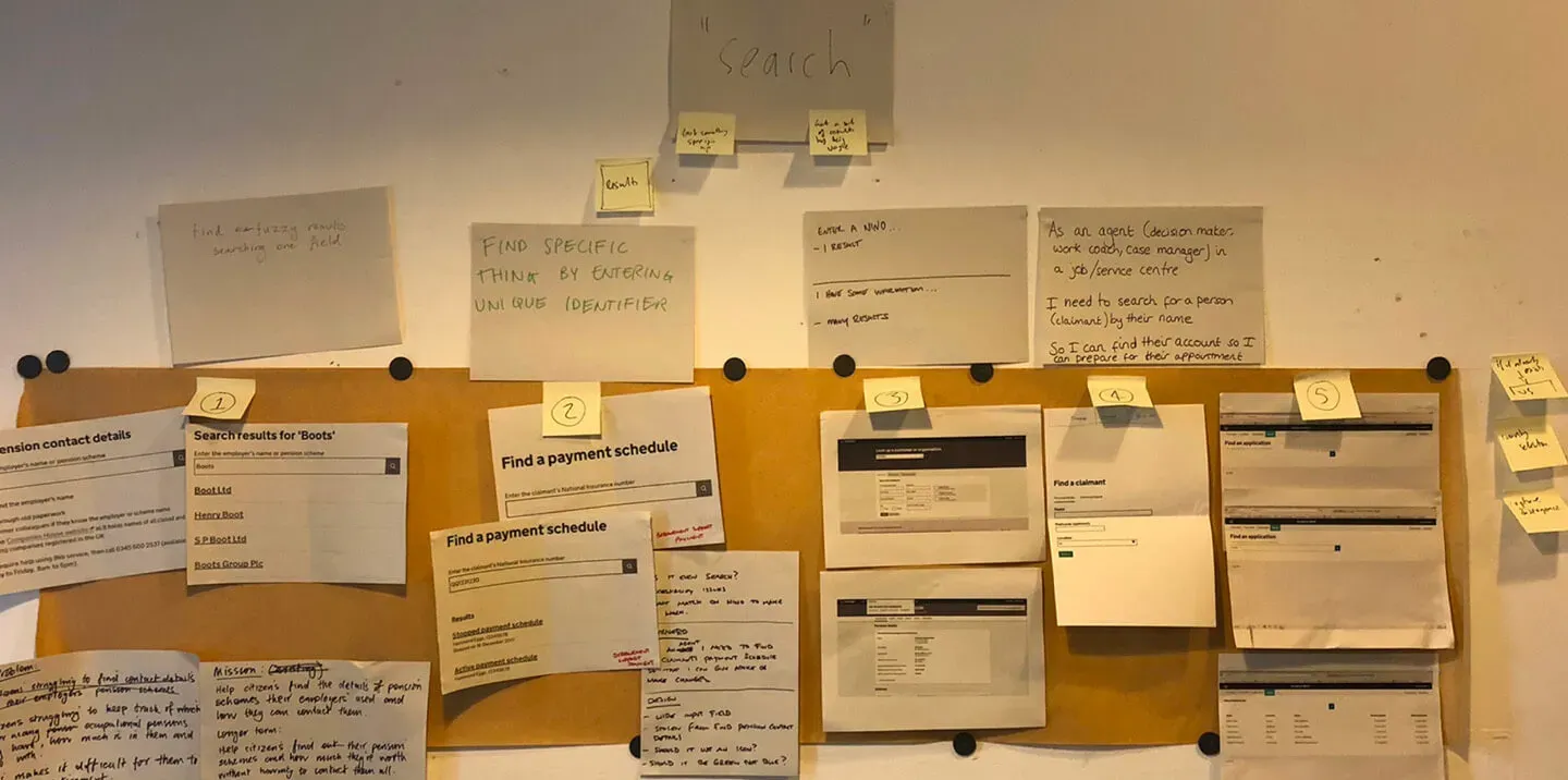 A collection of printed screenshots showing similar search components. There's hand written sticky notes all over the designs and they're grouped together into themes.